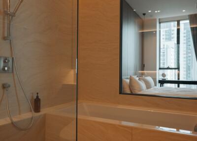 Modern bathroom with view into bedroom featuring large windows and cityscape