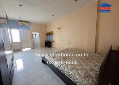 Spacious bedroom with large bed and kitchenette