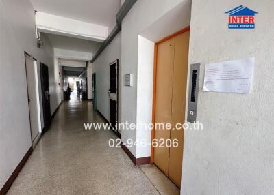 long corridor in residential building with multiple doors