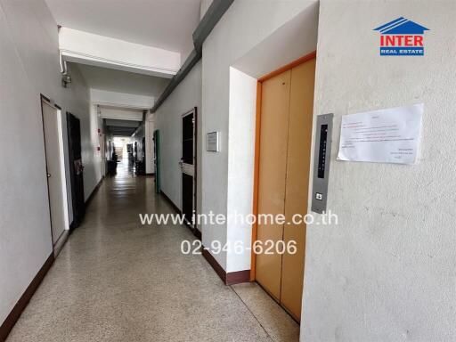 long corridor in residential building with multiple doors