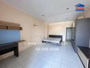 Spacious bedroom with kitchenette and modern amenities in an apartment