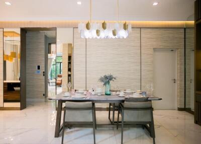 Elegant dining room with modern chandelier and stylish table setting