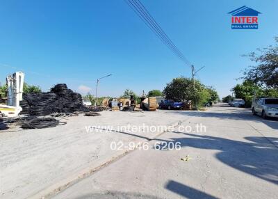 Outdoor view of a spacious industrial lot with available materials and machinery