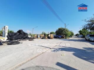 Outdoor view of a spacious industrial lot with available materials and machinery