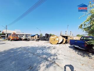 Industrial site with equipment and trucks under clear sky