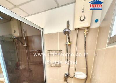 Modern compact bathroom with shower and water heater
