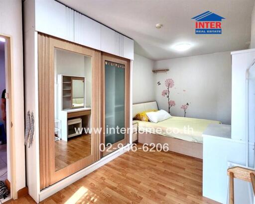 Modern bedroom with wooden flooring and built-in wardrobe