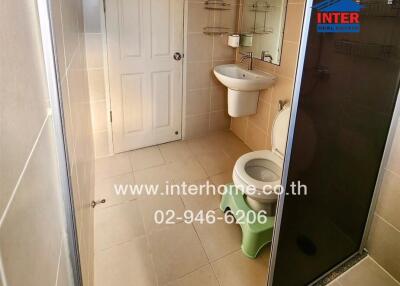 Compact bathroom with modern fixtures and tiled floor