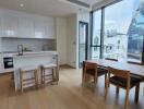 Modern kitchen and dining area with city views