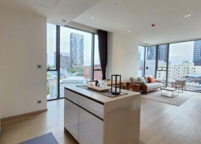 Modern living room with open kitchen and city view