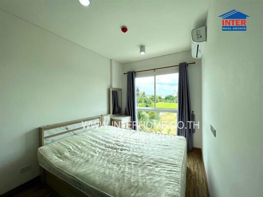 Bright and spacious bedroom with large window and scenic view