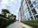 Exterior view of modern residential apartment building with landscaped pathway