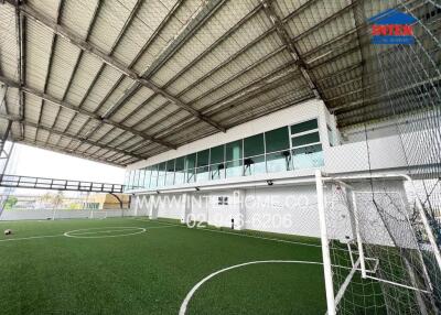 Indoor soccer field with artificial turf and covered roofing