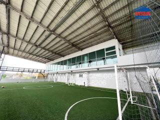 Indoor soccer field with artificial turf and covered roofing