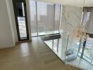 Elegant apartment living area with glass balustrade and city views