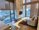 Spacious and modern living room with wide windows and city view