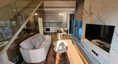 Modern living room with open kitchen and staircase