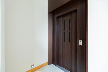 Modern wooden door in a bright minialistic corridor