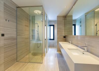 Modern spacious bathroom with dual sinks and large shower