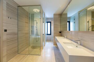 Modern spacious bathroom with dual sinks and large shower