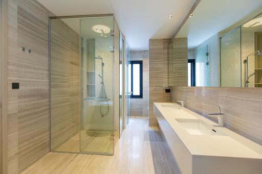 Modern spacious bathroom with dual sinks and large shower
