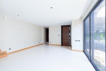 Spacious and bright living room with large windows and clean design