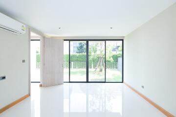 Spacious and modern living room with large windows overlooking the garden