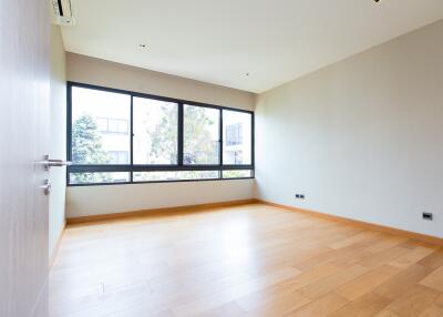 Spacious and well-lit empty living room with large windows