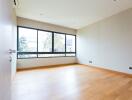 Spacious and well-lit empty living room with large windows