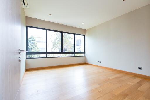 Spacious and well-lit empty living room with large windows