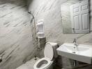 Modern bathroom with marble tiles and white fixtures