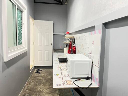 Compact laundry room with modern appliances and artistic wall design