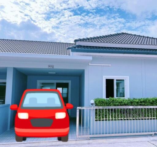 Exterior view of a modern house with a red car parked in front