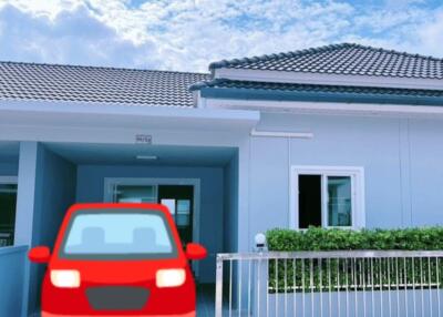 Exterior view of a modern house with a red car parked in front