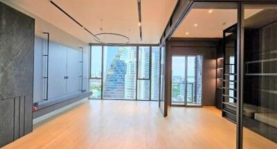 Spacious living room with large windows and city view