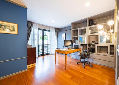 Spacious home office with modern desk and hardwood flooring