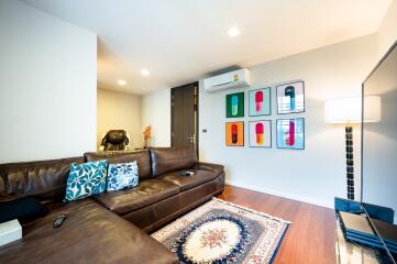 Spacious living room with leather sofa and modern decor