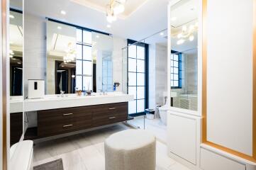Modern bathroom with large mirrors and stylish lighting