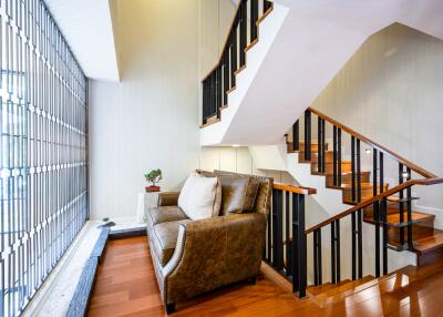 Stylish living room with modern staircase and natural light