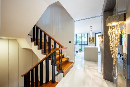 Modern living room interior with elegant staircase and artistic chandelier