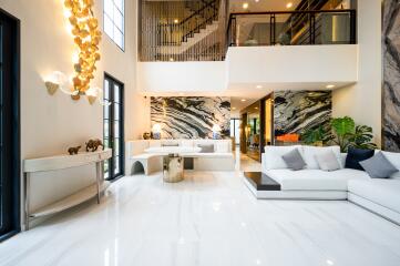 Spacious modern living room with marble floors and large, striking wall art