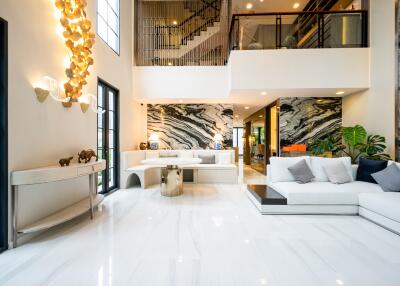 Spacious modern living room with marble floors and large, striking wall art