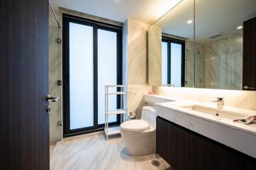 Modern bathroom with large windows and marble finishes