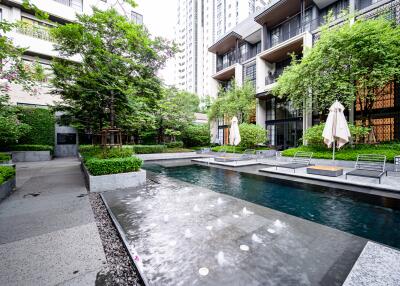 Modern apartment complex outdoor area with swimming pool and seating spaces