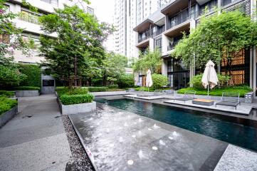 Modern apartment complex outdoor area with swimming pool and seating spaces