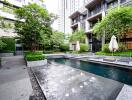 Modern apartment complex outdoor area with swimming pool and seating spaces