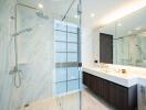 Modern spacious bathroom with large mirror and glass shower