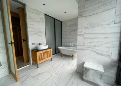 Luxurious marble bathroom with freestanding tub and modern amenities