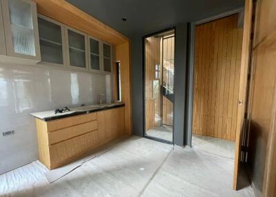 Under construction kitchen with wooden cabinets and sliding door