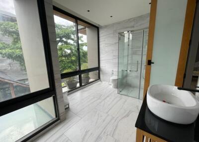 Modern bathroom with large windows and marble flooring